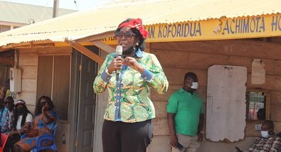Della Sowah addressing a group of people at the lorry station