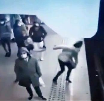 Footage captured the man running forward to push the woman