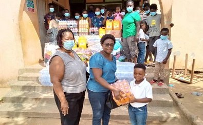 • Madam Osei Owusu (front, middle), presenting some of the items to Awurama Akyaa, an inmate of the orphanage