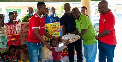 • Mr Kwabena Boakye Antwi (second from right) and other members of the association presenting the items to the children