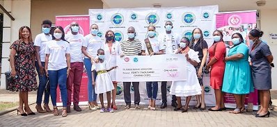 Miss Ghana Foundation together with staff of FOCOS Hopsital in a photograph with little Linda and her father
