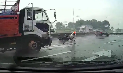 The motorcyclist lost his balance on the slippery road