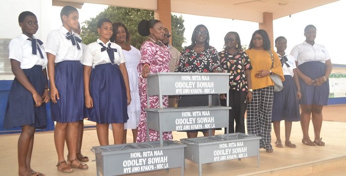 Ms Sowah (fifth from left) presenting the stoves to Mrs Obuo-Nti Photo - Victor A. Buxton
