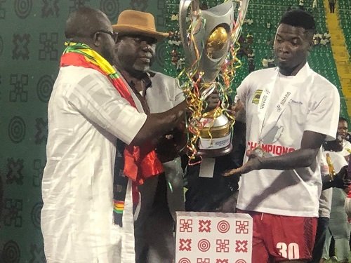Mr Kurt Okraku (left) is joined by Lepowura Alhaji MND Jawula to present the GPL trophy to Abdul Ganiyu