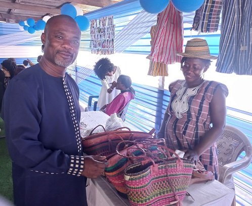 ●●Deacon Philip Quaye interacting with a member of the Deaf Ministry at the exhibition