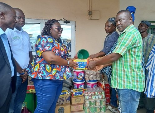 Madam Frimpong (left) presenting the items to the CEO of the Foundation (left)
