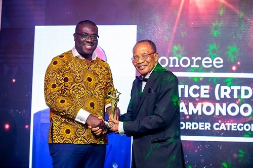 • Justice (RTD) J.C Amoonoo- Monney receiving his honour from NLA Boss, Sammy Awuku