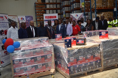 Officials at the function pose behind some of the batteries