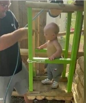 The man with his son in the wooden playhouse