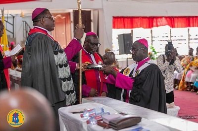 • Rt. Rev. Dr Dodd (right) receiving a bible from Most Rev. Dr. Boafo (left)