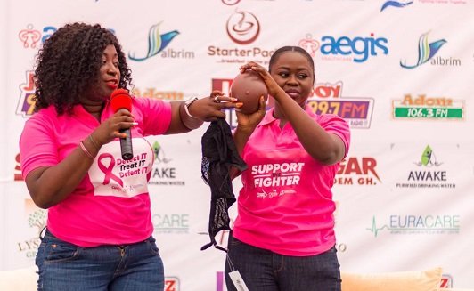 Madam Juliet Gyamfi (left) demonstrating how to wear prosthetis after masectomy