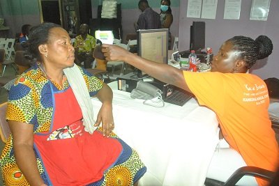 Nurse screening a market woman