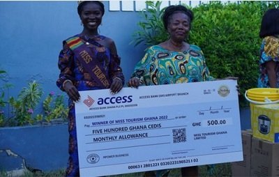 Reining Miss Tourism Ghana receives her monthly allowance cheque from Mrs.Delphine Brew-Hammond