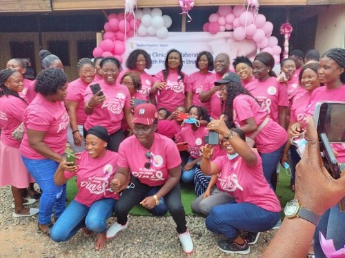 •Some staff of Madina Polyclinic Kekele pose with officials after the programmee