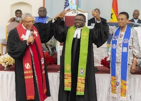 ) Rev Kumi-Duodu (left) and Prof Mrs Mabel Asante, First Clerk of the Presbytery, both raised Rev Dr. Awuku-Gyampoh's hands to introduce him to the congregation.