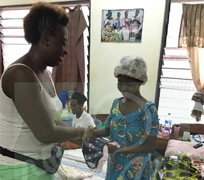 • Mrs. Mayne-Eghan making a donation to a mother of a preterm baby