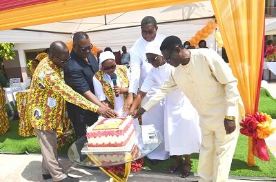 Rev. Damalie (3rd from left) being assisted by Dr Laast (second from left) and other dignitaries to cut the anniversary cake Photo. Vincent Dzatse