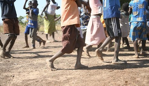 Pupils walk bare foot to school