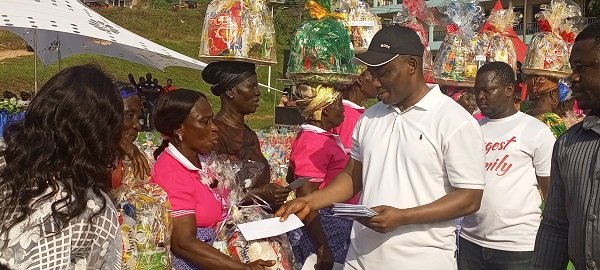 George Duker presenting cash to the widows