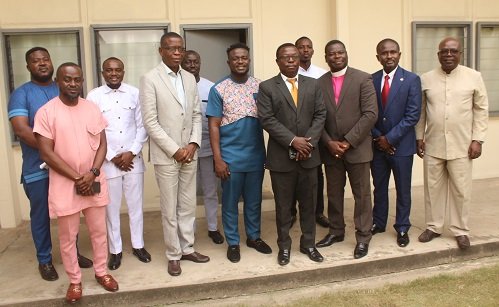 Mr Martin Adu Owusu (middle) with guests and some mangement staff of NTC