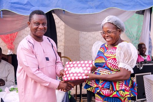 • Mrs. Mina Tweneboa-Kodua (right) receiving a gift from Mr. Abraham A. Aikins