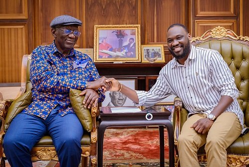 • Mr. Ohene Kwame Frimpong, owner of the product, receiving a handshake from former President Kufuor