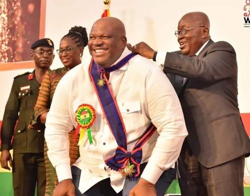 • President Akufo-Addo decorating Mr Henry Quartey