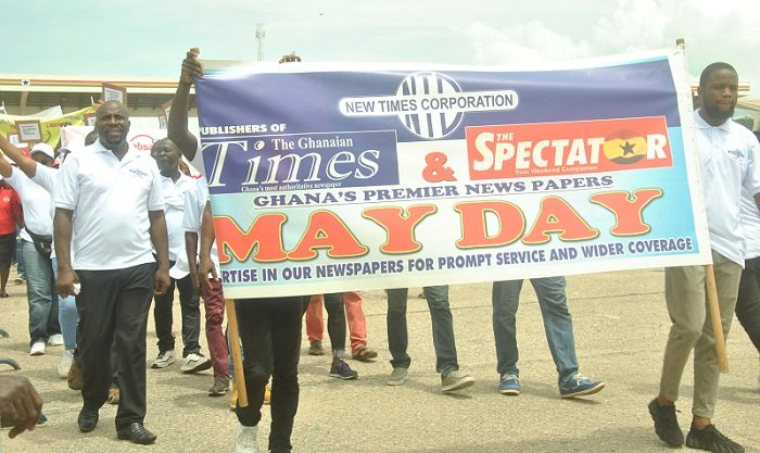 Some of the workers marching pass the dais