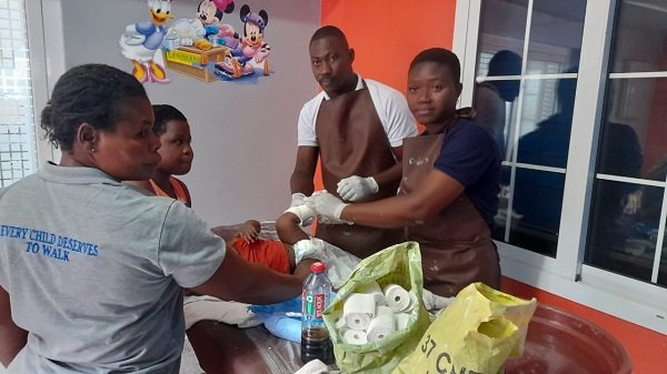 Healthworkers at 37 Military Hospital attending to a child with clubfoot