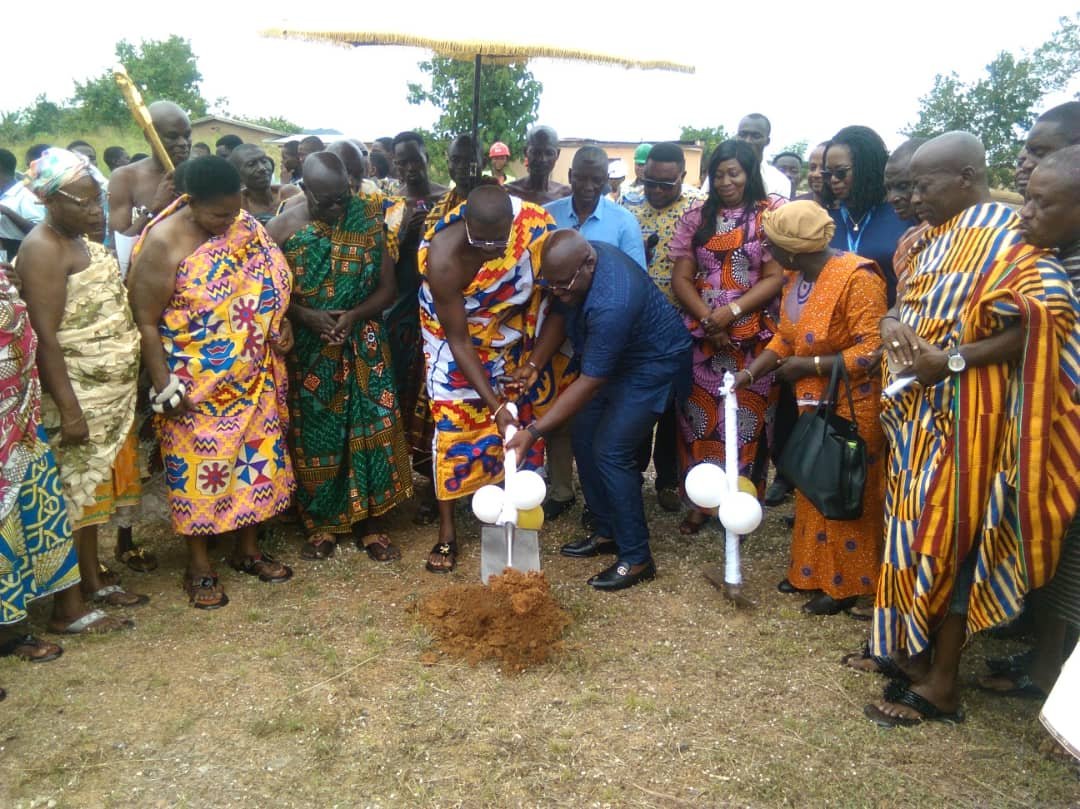 Mr Seth Acheampong (in blue black political suit) being assisted by Nana Twumasi Dankwa to break the grounds for the start of the project