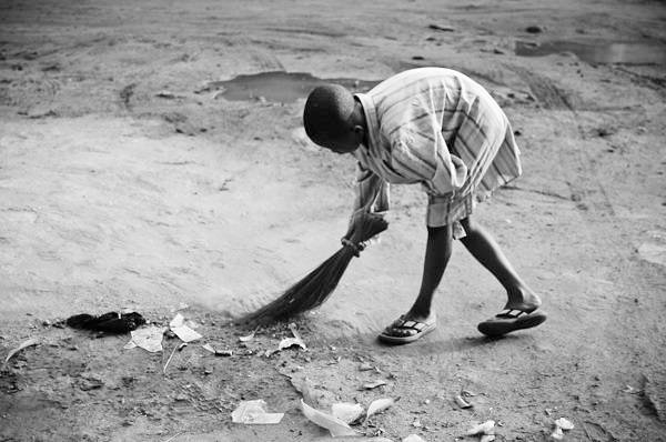 A young boy sweeping