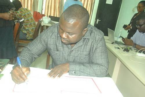 Mr Albert Dwumfour signing the book of Condolence