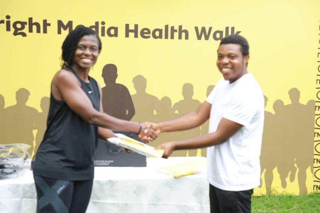 Mr Kofi Ahovi (right) receives a prize from Madam Wiafe