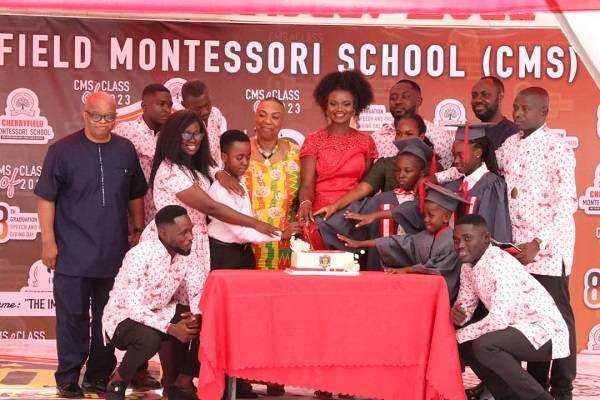 Staff, joined by some guests and pupils to cut the anniversary cake