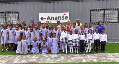 Dignitaries at the event with the children in a photograph