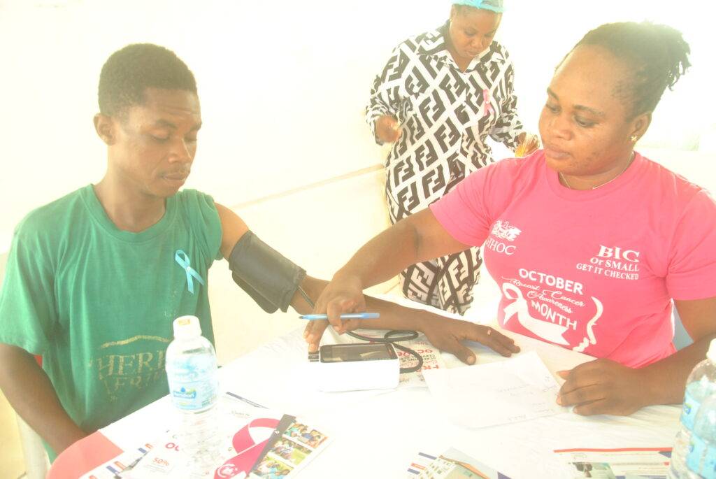 Health professional checking the blood pressure of a staff member of GIHOC
