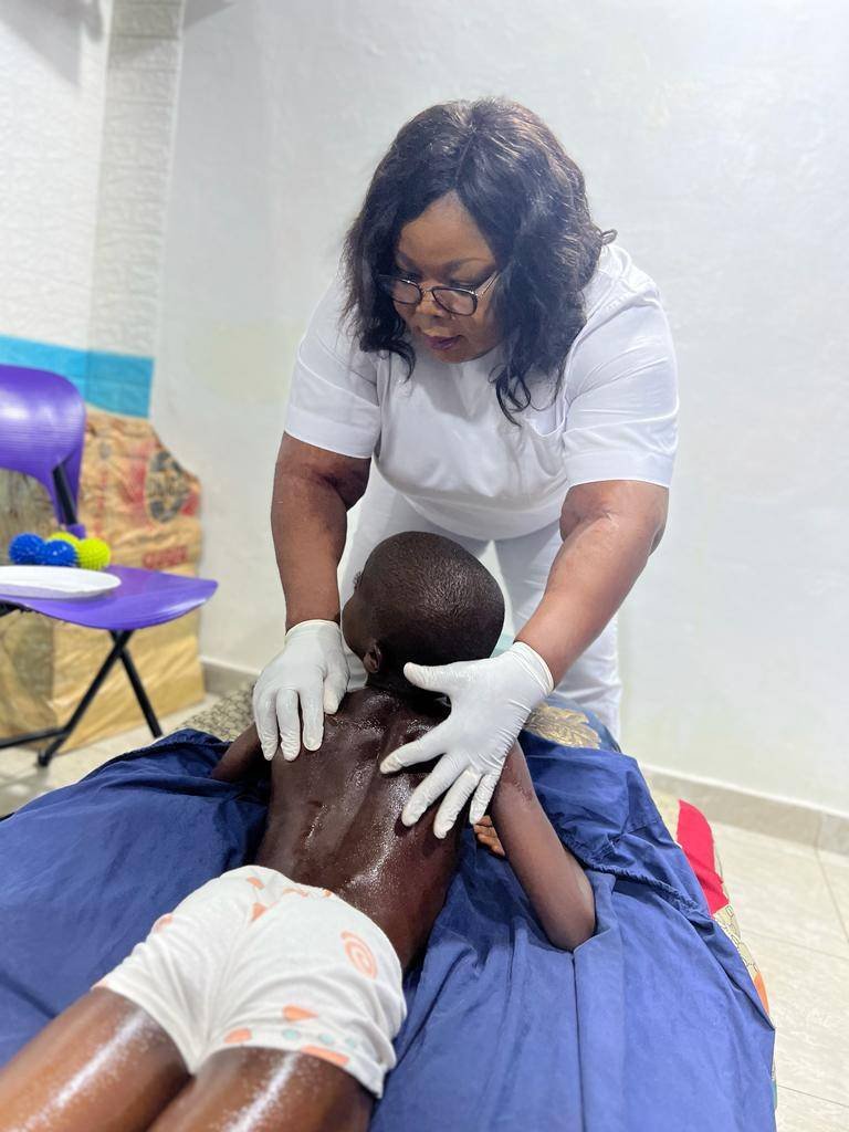 ●●Mrs Bertino attending to one
of the autistic children at her
facility