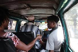 A mate taking fare in the commercial vehicle
