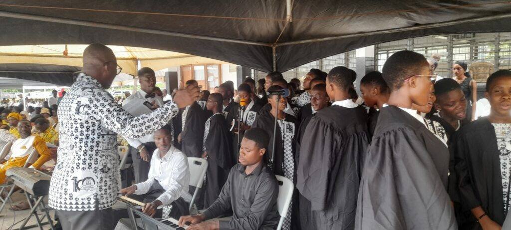 AHISCO choir conductor conducting  the choir to sing at the 100th anniversary