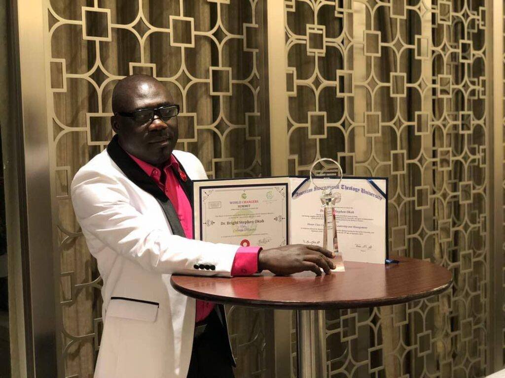 Dr Okoh displaying some of the awards