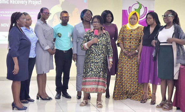 • Sustainability Manager of ABANTU, Hamida Harrison (front) launching the policy with other stakeholders