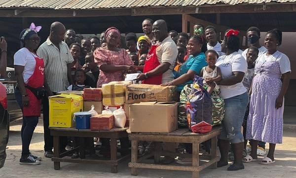 Mr Asante (right)presenting items to Madam Smith (left)