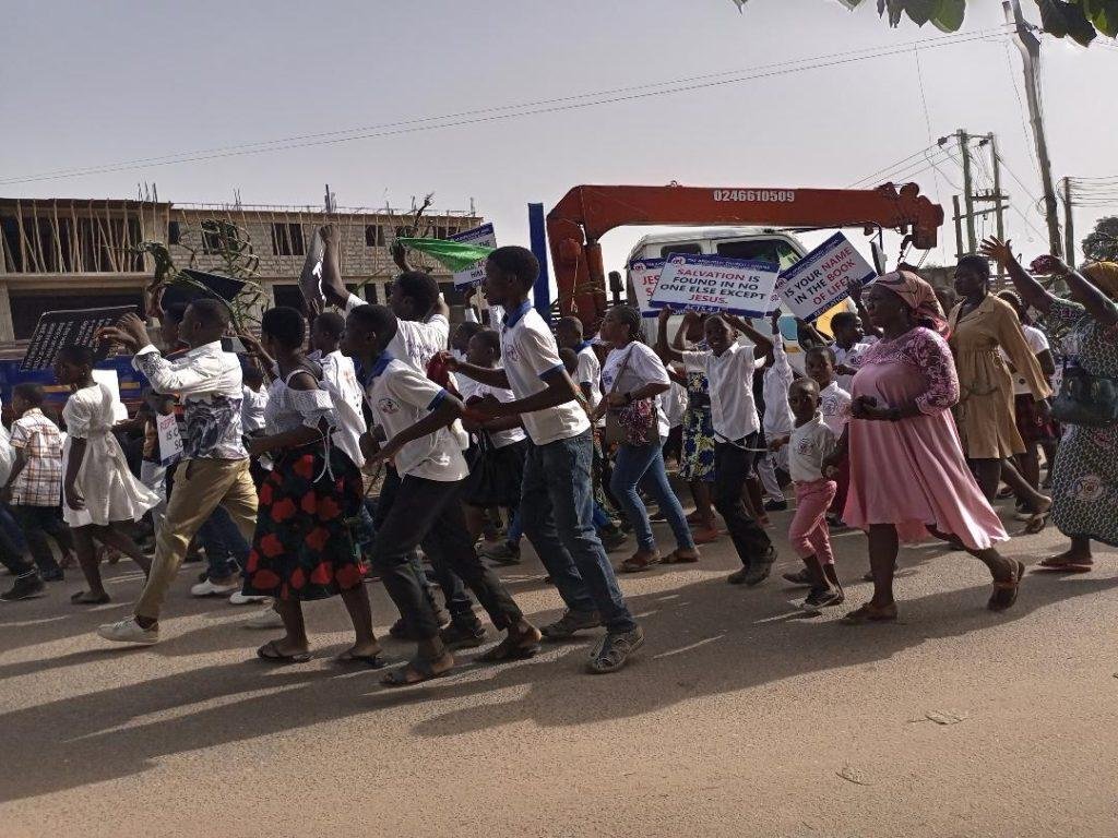 The children service of the Apostolic Church of Ghana Lapaz branch marching through the street with their palm fronds