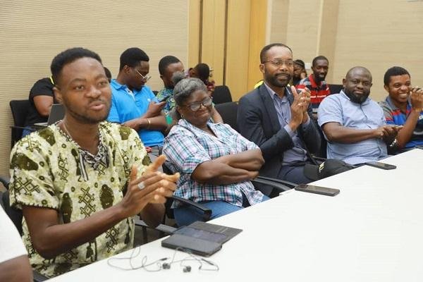 Media personnel applauding at the event