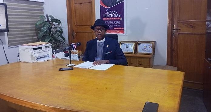 Rev Kennedy Okosun addressing the media