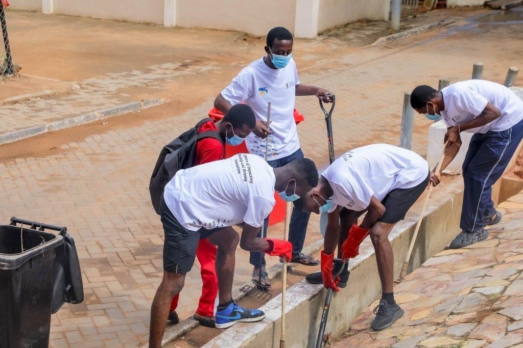 Students of ATU desilting  chocked gutters