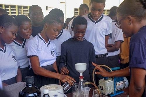 • Mrs Caroline Brown guiding students of St John’s Senior High School through an experiment.
