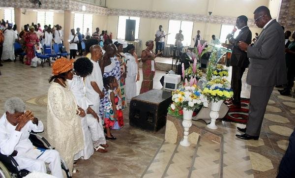 Pastor Samuel Kwesi Bonney,District Pastor of Adoagyiri and Pastor Peter Godson Andoh(rtd) praying for the retirees