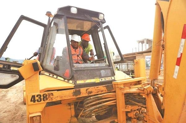 Rev Wengam drives one of the earth moving machines at the site