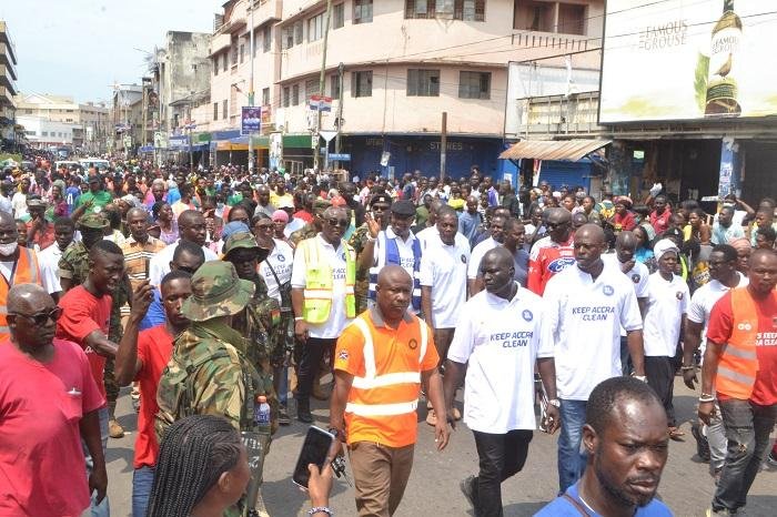 • King Tackie Teiko Tsuru II (in reflectors) with other dignitaries and city authorities inspecting the exercise